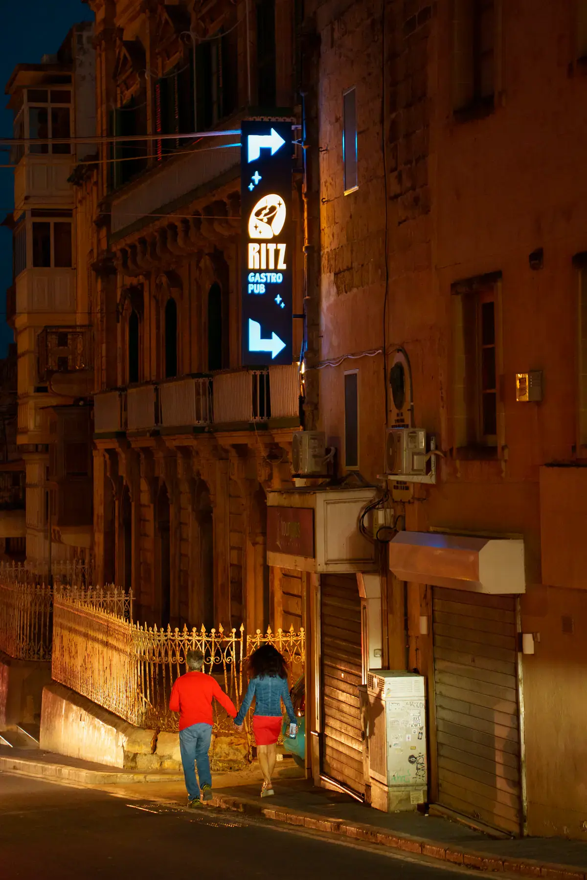 A narrow Victoria street at night leading to the Ritz