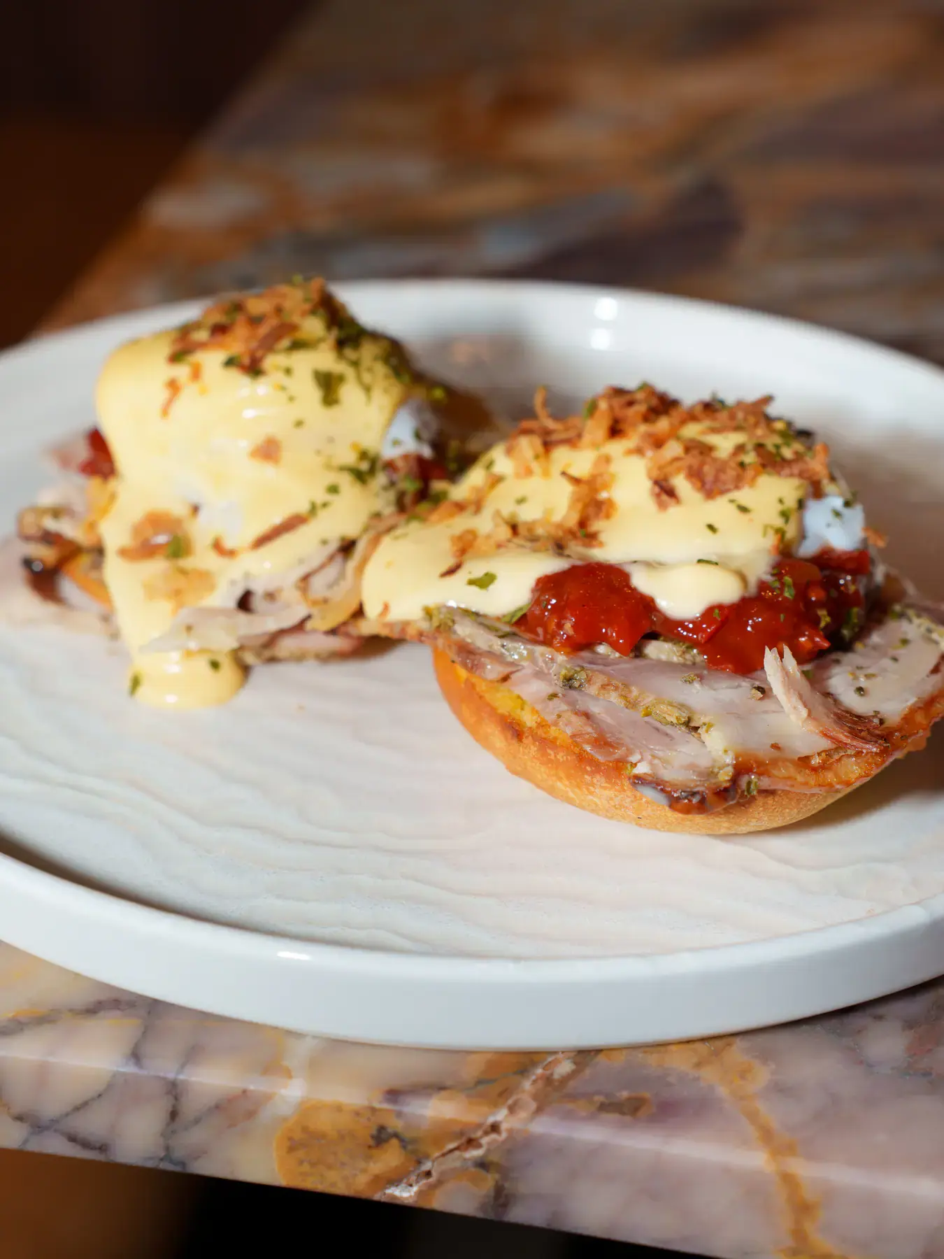 Eggs Benedict on toasted English muffins with hollandaise