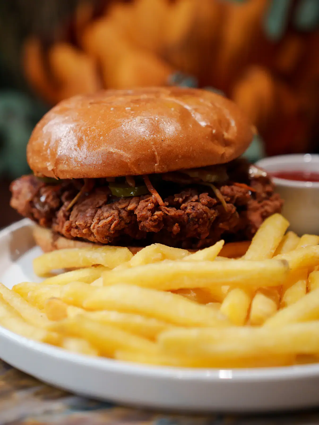 Crispy chicken burger in a brioche bun with fries