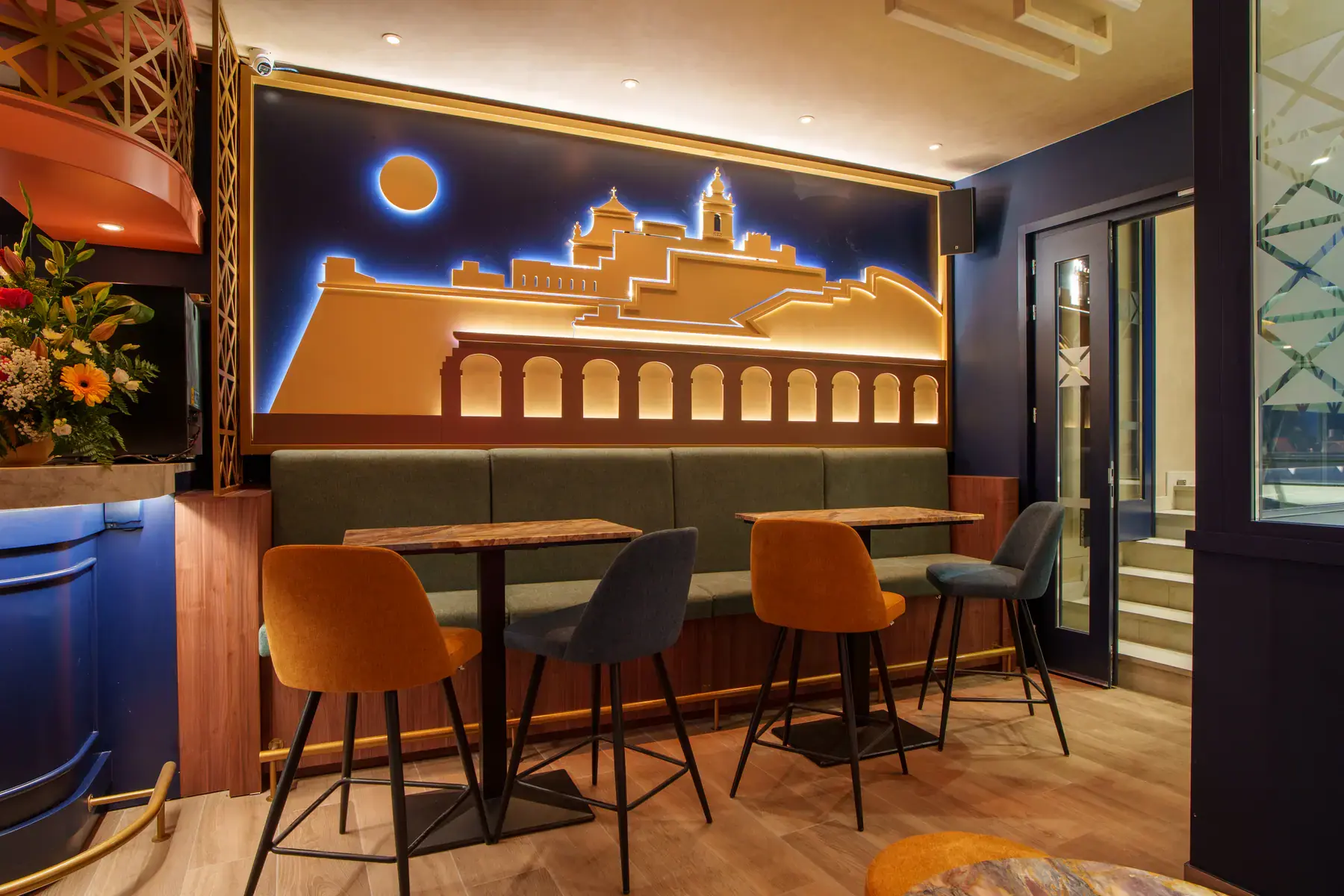 High tables beneath the Cittadella skyline wall
